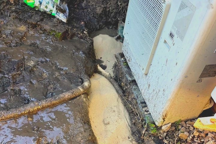 Water flooding across a driveway from a broken line